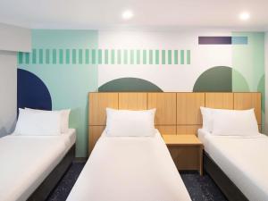 Postel nebo postele na pokoji v ubytování ibis Styles Sydney Central