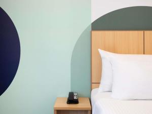 Postel nebo postele na pokoji v ubytování ibis Styles Sydney Central