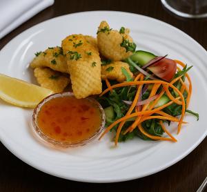 a plate of food with shrimp and vegetables and dipping sauce at MOTEL ROYAL TARA in Binalong