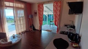 a living room with a view of a living room at Taapuna Guest House in Punaauia