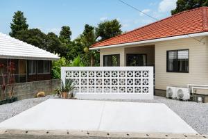a white fence in front of a house at Machicanty -まちかんてぃ- in Motobu +32 photos