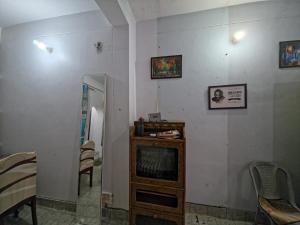 a living room with a fireplace and a table and chairs at Grandma s Nest in Bhīm Tāl