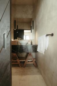 a bathroom with a sink and a counter with a mirror at The Iggy Hotel Seseh Studio 1 Sauna, Ice Bath in Cemagi