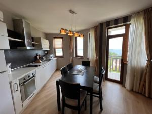 a kitchen with a table and a dining room at Saint Thomas Holiday Village Condo in Sozopol