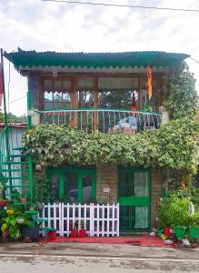 a house with a white fence in front of it at The Money Plant House in Nainital