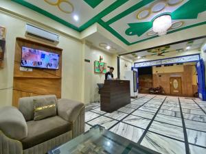 a man standing at a podium in a lobby at Hotel Diamond in Jaipur