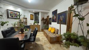 a living room with a table and a couch at Casa ROMERO EN FLOR in Medellín