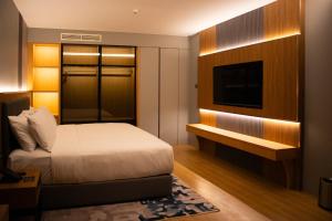 Ένα ή περισσότερα κρεβάτια σε δωμάτιο στο Aglow Hotel Harbor Bay Batam