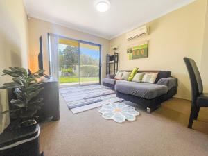 a living room with a couch and a table at Ground Garden-Two King Beds&One Queen Bed in Perth +17 photos