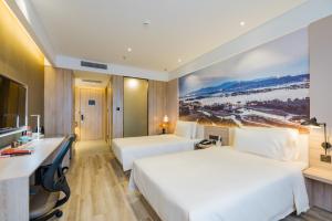 a hotel room with two beds and a desk at Atour Hotel (Suzhou Wujiang Fenxi) in Suzhou +38 photos