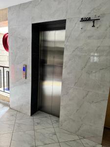a elevator in a building with a metal door at The Skyline Loft in Juja