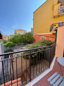 a balcony with a table and chairs next to a building at Casa Giulé in Imperia