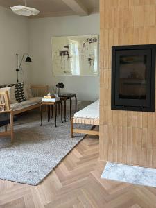 a living room with a fireplace and a tv at Historic Apartment At Karljohansvern In Horten in Horten