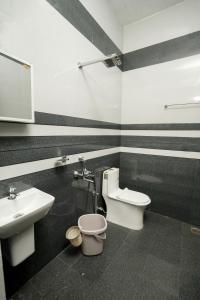 a bathroom with a toilet and a sink at Royal Turn Modern Villa in Alleppey +22 photos