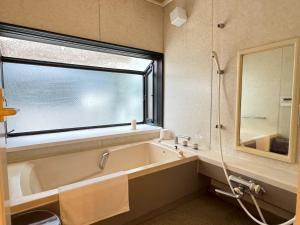 a bathroom with a tub and a large window at and CITY三軒茶屋 in Tokyo +69 photos
