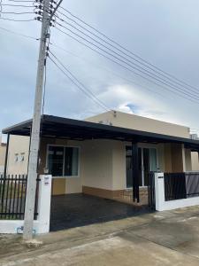 a small house with a pole in front of it at FUJI Hotel in Nakhon Ratchasima