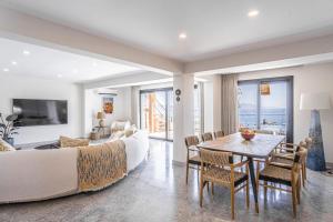 a bedroom with a bed and a dining room with a table at Villa Onya in Bodrum City