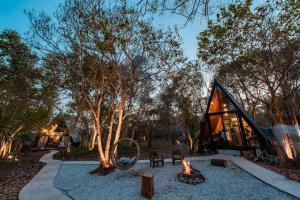 a cabin in the woods with a fire in the yard at Issara Bar&House in Ko Larn