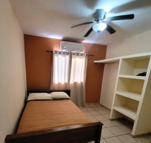 a bedroom with a bed and a ceiling fan at Casa céntrica--zona vado del rio in Hermosillo +4 photos