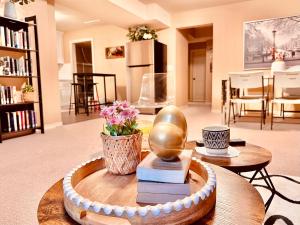 a room with a table with a statue and books at Scorpion Hiuse Langley -Two rooms Family suite in Langley