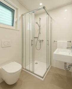 a bathroom with a shower and a toilet and a sink at Salum in Trogir +24 photos