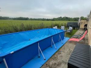 a blue swimming pool on the roof of a house at Maison " Pac-Man" entre collègues, amis, famille - barbecue - Netflix - Prime - Baby foot 50cts - jusqu'à 9 personnes - in Saint-Seurin-sur-lʼIsle