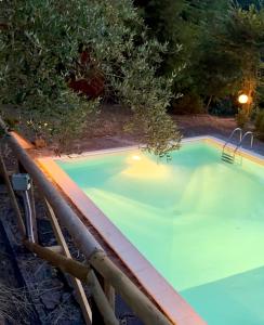 an empty swimming pool at night at La casa nel bosco in Lari