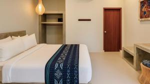 Postel nebo postele na pokoji v ubytování Pandan Bungalows