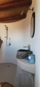 a bathroom with a toilet and a mirror on the wall at L'Olivuzza in Alicudi
