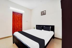 Postel nebo postele na pokoji v ubytování Super Hotel O Viswapuram