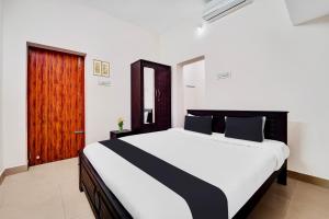 Postel nebo postele na pokoji v ubytování Super Hotel O Viswapuram