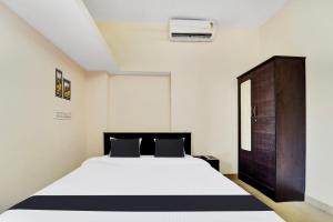 Postel nebo postele na pokoji v ubytování Super Hotel O Viswapuram