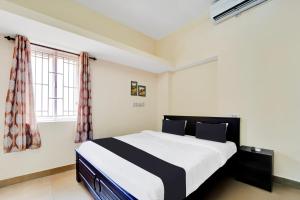 Postel nebo postele na pokoji v ubytování Super Hotel O Viswapuram