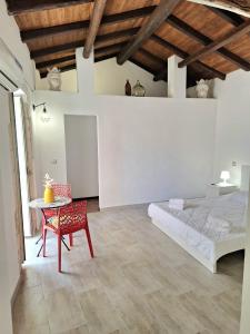 a bedroom with a bed and a table and a chair at Nata Sicula 3 in Siracusa
