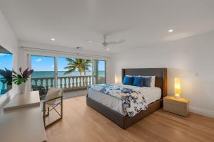 a bedroom with a bed and a view of the ocean at Lanikai Sunrise in Kailua +32 photos