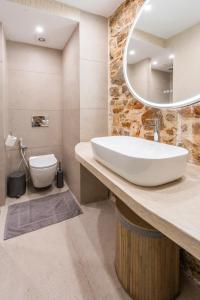 a bathroom with a large white sink and a toilet at Casita in Ermoupoli +35 photos