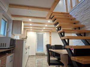 a spiral staircase in a kitchen with a table and chairs at Sun House Luka in Radmirje