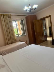 a bedroom with two beds and a window at Villa Tirana in Tirana