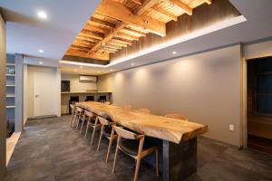 a large conference room with a long table and chairs at 民宿ととのい処ゑびすや in Unzen