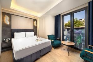 a hotel room with a bed and a table and chairs at Lenus Hagia Sophia Hotel in Istanbul