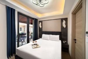 a bedroom with a bed with a gold book on it at Lenus Hagia Sophia Hotel in Istanbul +24 photos