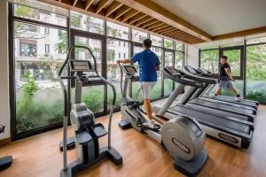 a man and a boy on a treadmill in a gym at Golden sunshine studio-Sea view &Nelflix Free in Ha Long