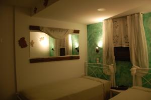 a small bedroom with two beds and a mirror at Aegean Pearl in Áyios Dhimítrios +69 photos