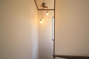 a bathroom with a shower with lights on the wall at 箱根御泊処-紅葉- 049bH in Hakone +49 photos