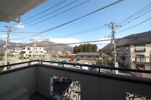 a balcony with a view of a city at 箱根御泊処-紅葉- 049bH in Hakone