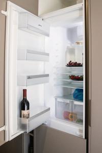 a refrigerator with a bottle of wine in it at Le Chic - Luxury meets Lifestyle in Johannesburg