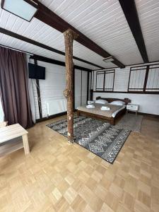 a room with a bed and a tree in it at Chalet Shepit Karpat in Bukovel +30 photos