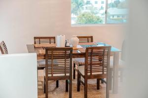 a dining room with a wooden table and chairs at Maroochydore Coastal Suite in Maroochydore