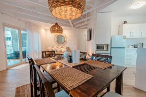 a dining room with a table and a kitchen at Maroochydore Coastal Suite in Maroochydore +29 photos