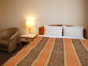 Postel nebo postele na pokoji v ubytování Sakaide Grand Hotel